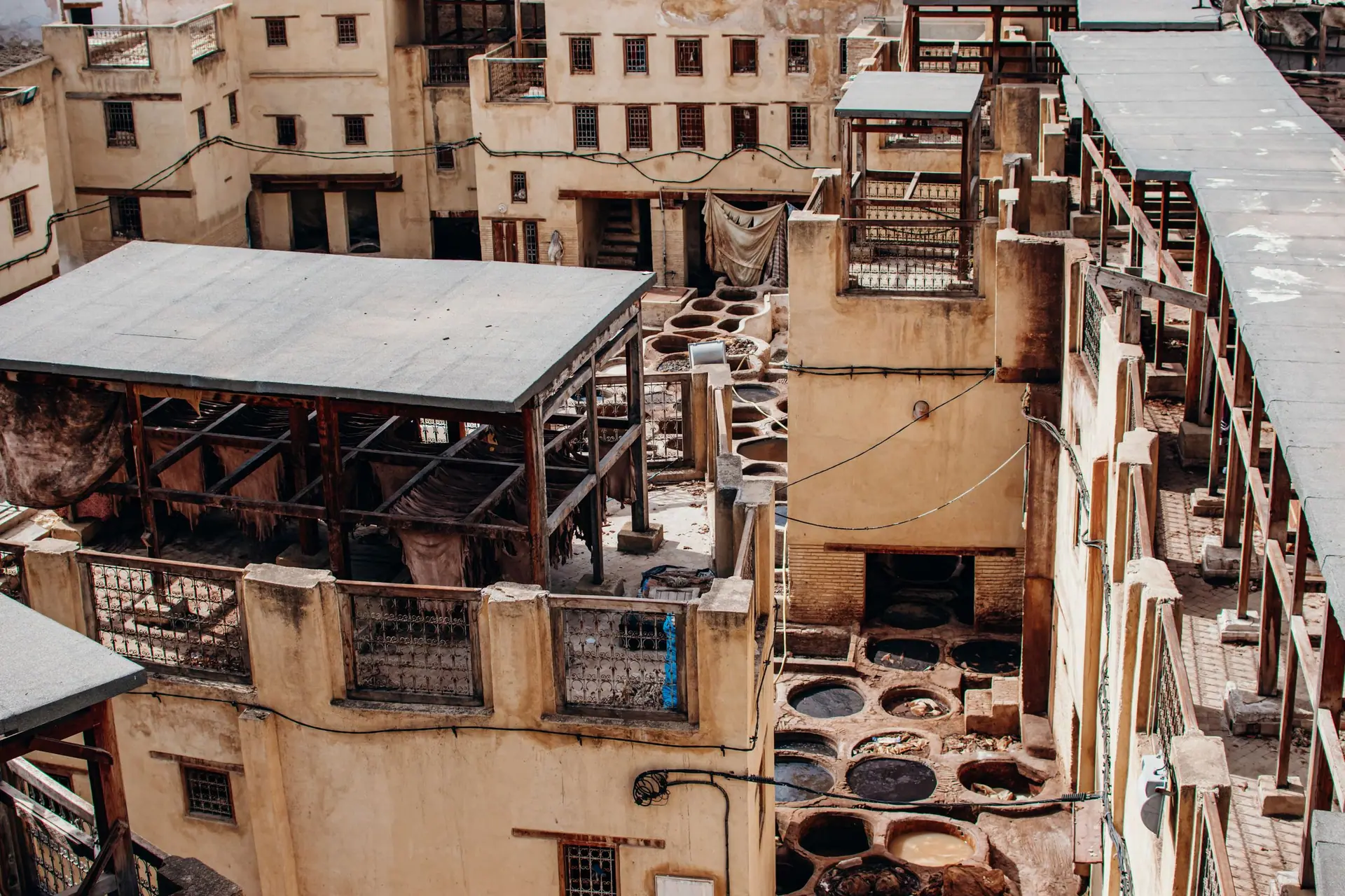 Aerial view of Chouara Tannery in the old town of Fes, Morocco showcasing traditional tanning pits.