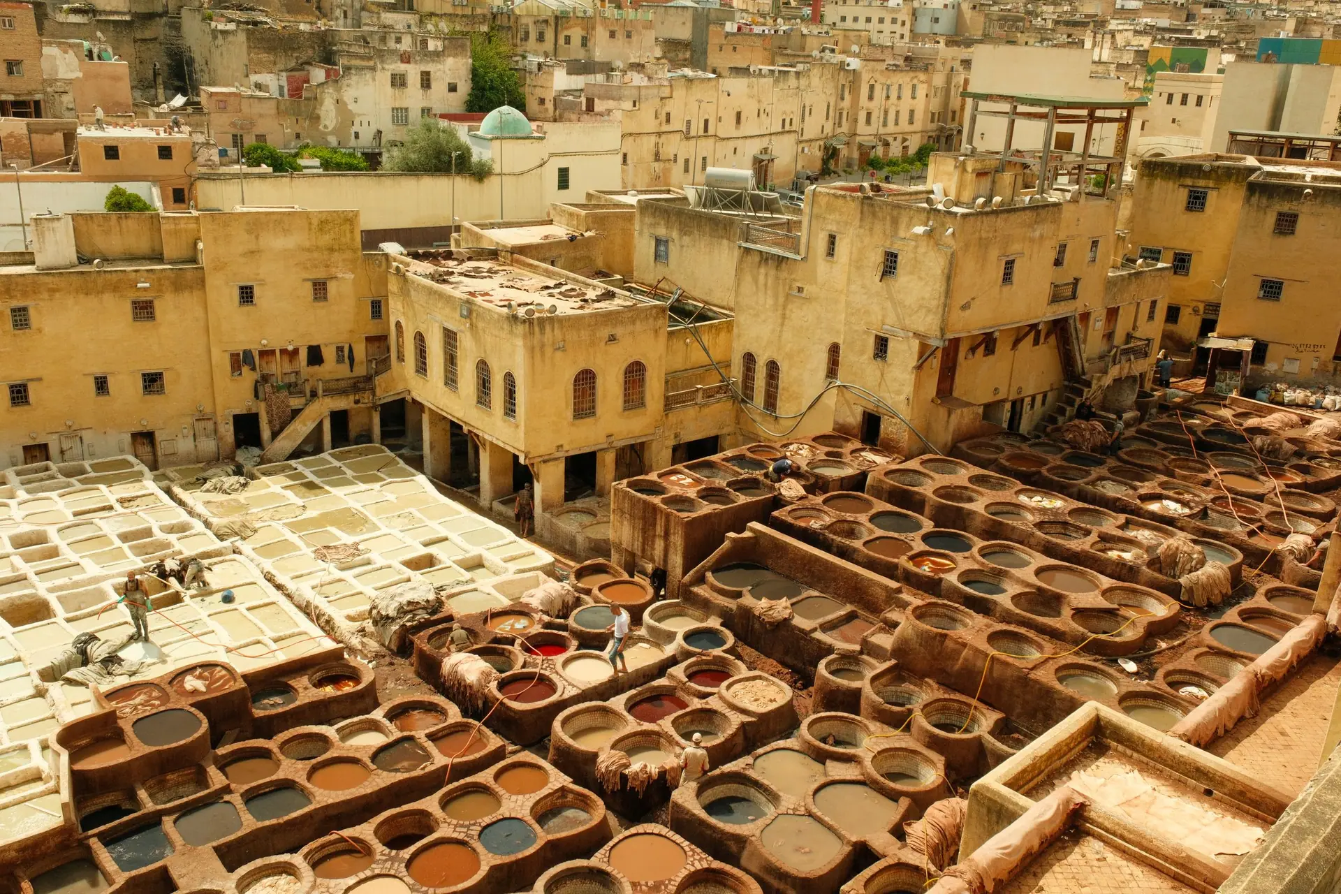 Aerial view of the historic leather tannery in Fez, Morocco, showcasing vibrant dye vats.