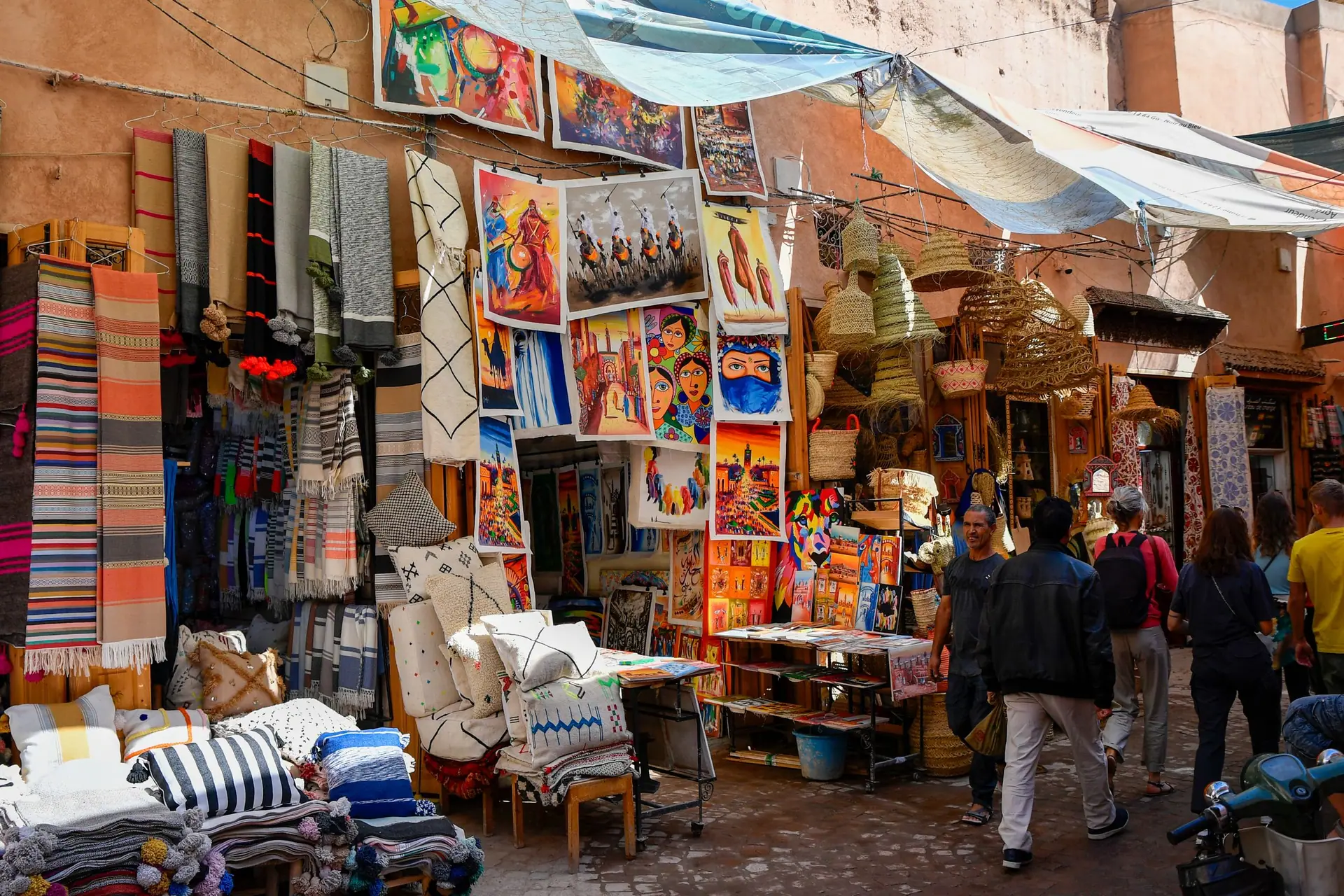 Explore Marrakesh's vibrant souk with colorful textiles and art in the bustling Medina.