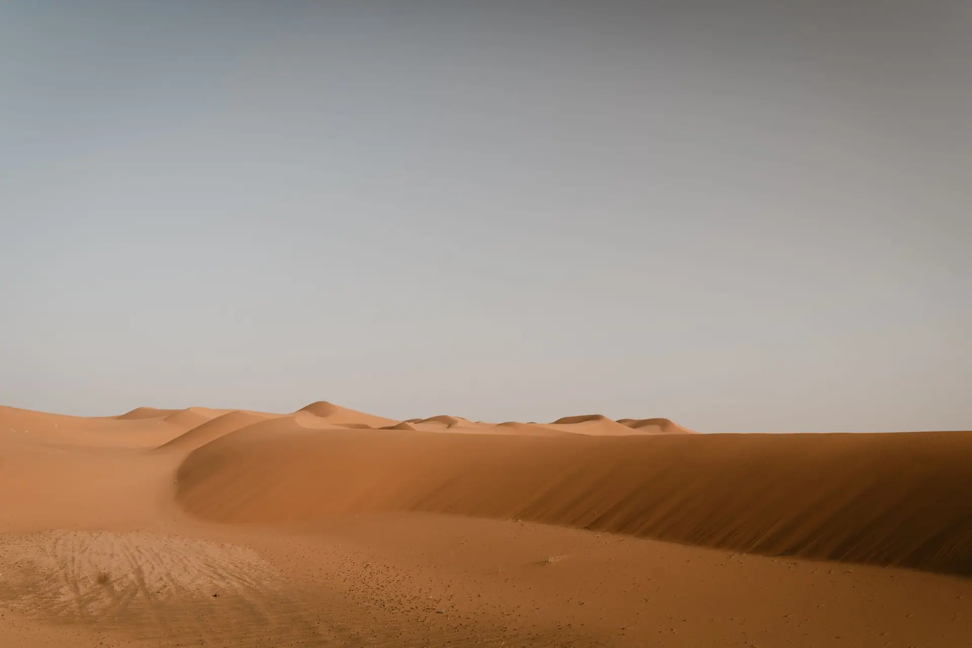 Expansive sand dunes in Merzouga, capturing the serene beauty of the Moroccan Sahara Desert.